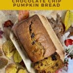 Sliced Pumpkin Bread on a wood tray surrounded by Fall leaves on a brown scarf from overhead Pinterest banner.