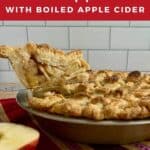 Apple Pie in pan with lifted slice & apples on a purple striped towel Pinterest banner.