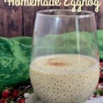 Glass of eggnog with pinecones on top of festive towels Pinterest banner.