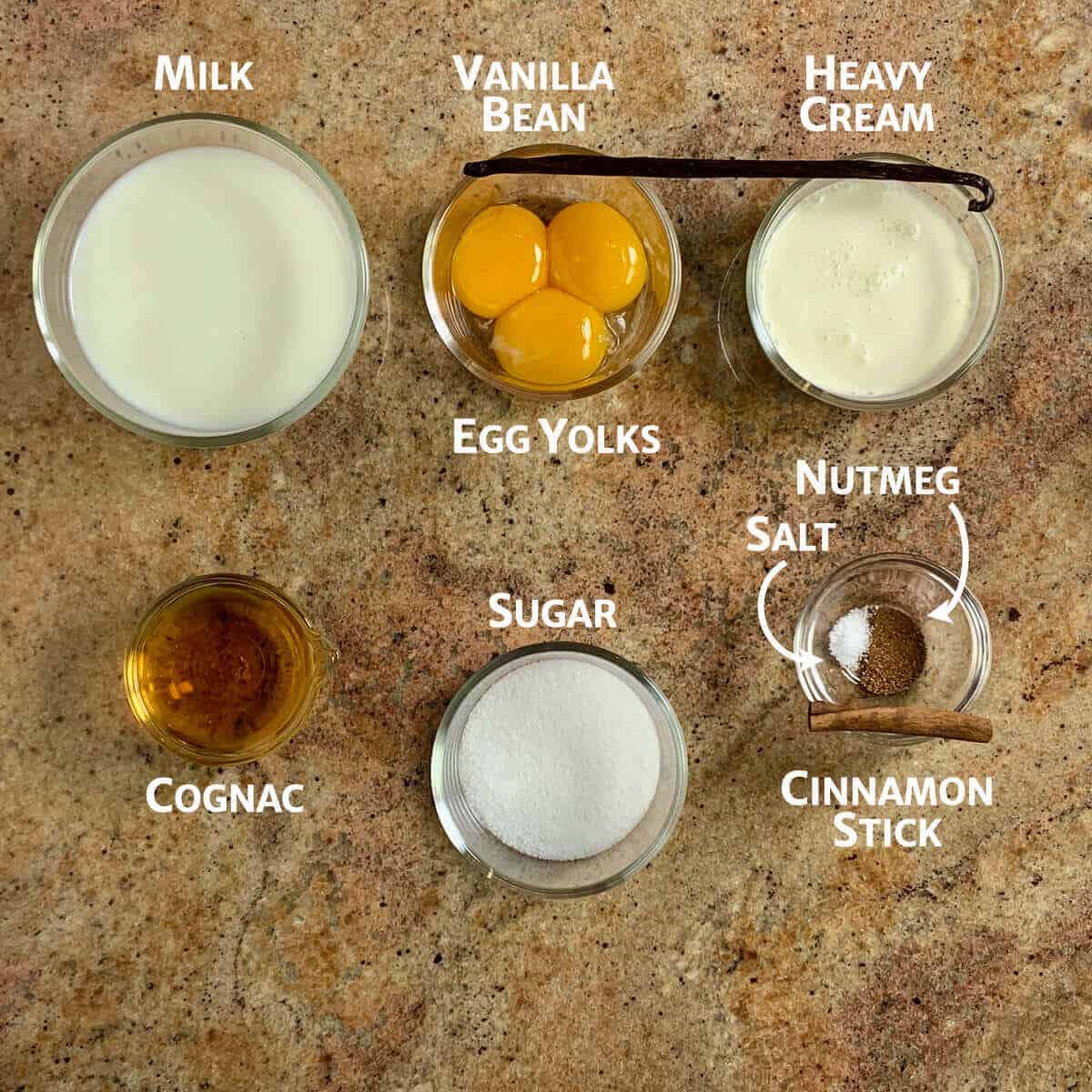 Eggnog ingredients portioned in glass bowls.