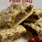 Closeup of pecan bars stacked on a white plate surrounded by pecans, brown sugar, and red berries Pinterest banner.