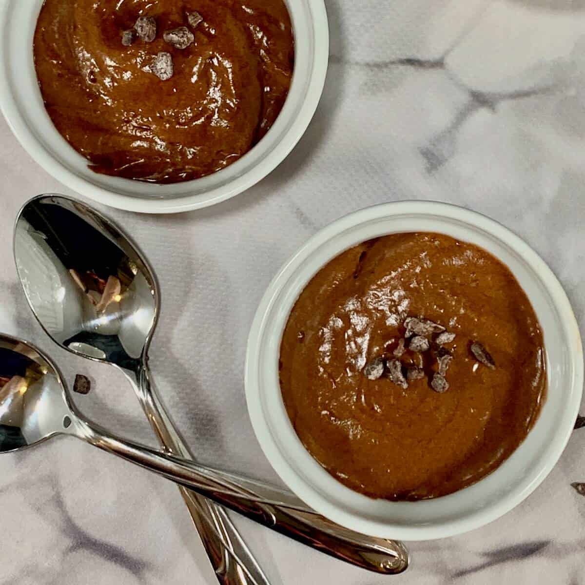 Dairy-Free Chocolate Mousse in white ramekins with spoons from overhead.