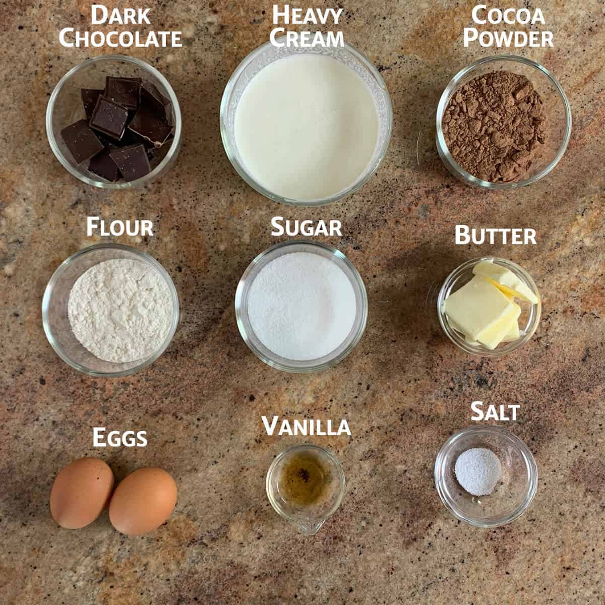 Ingredients for Chocolate Mousse Cake portioned in glass bowls from overhead.