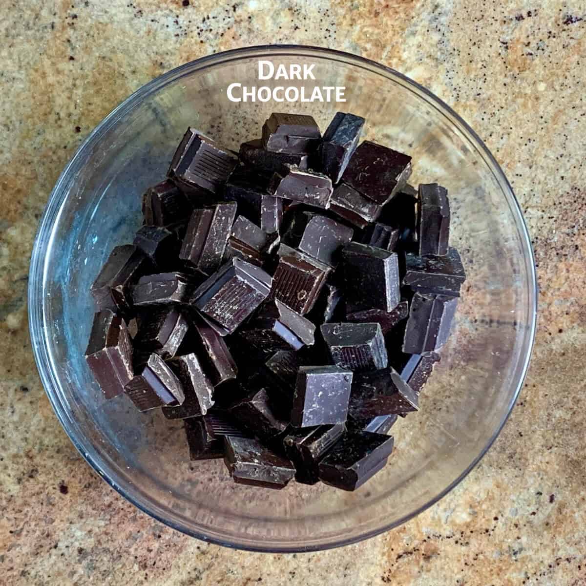 Chopped chocolate in a glass bowl.