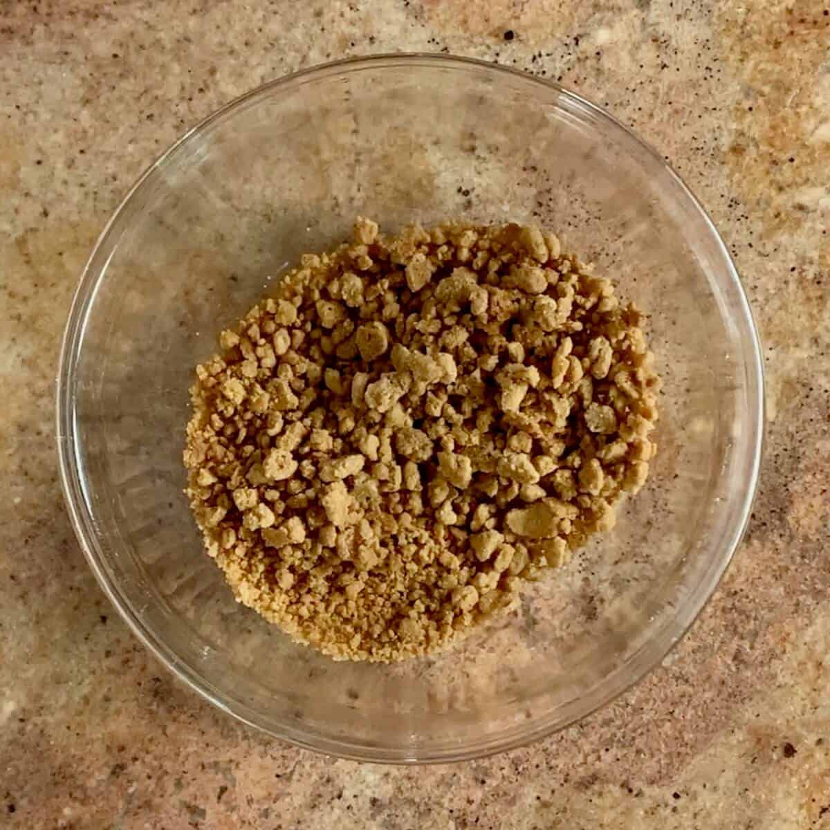 Finished cinnamon streusel crumb topping in a glass bowl.