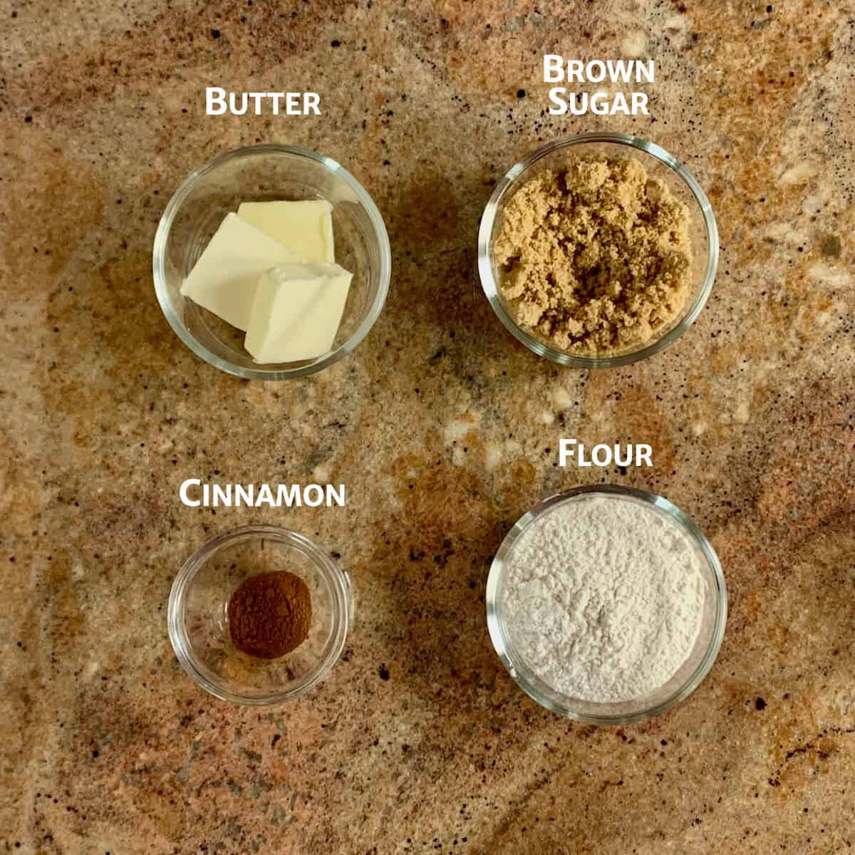 Ingredients for cinnamon streusel topping portioned in glass bowls.