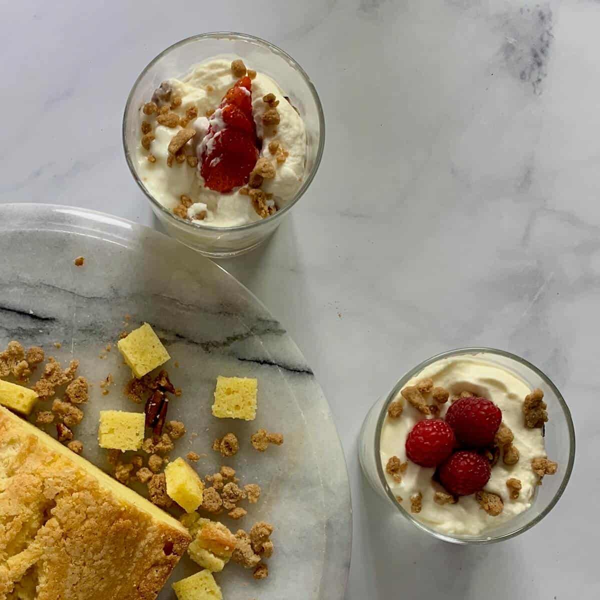 Cinnamon Crumble Trifle in a glass with another glass of trifle and a pound cake from overhead.