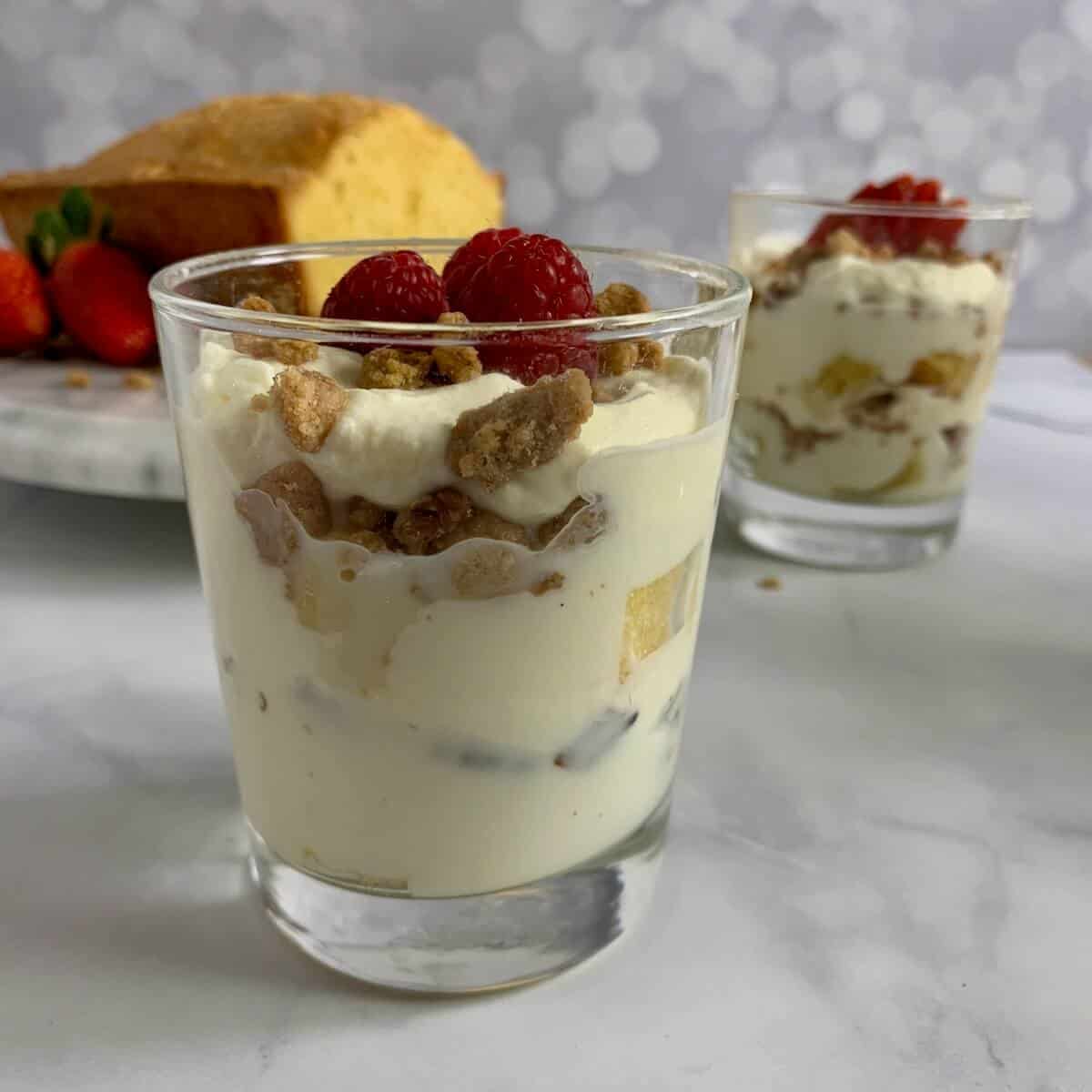 Cinnamon Crumble Trifle in a glass in front of another glass of trifle and a pound cake.