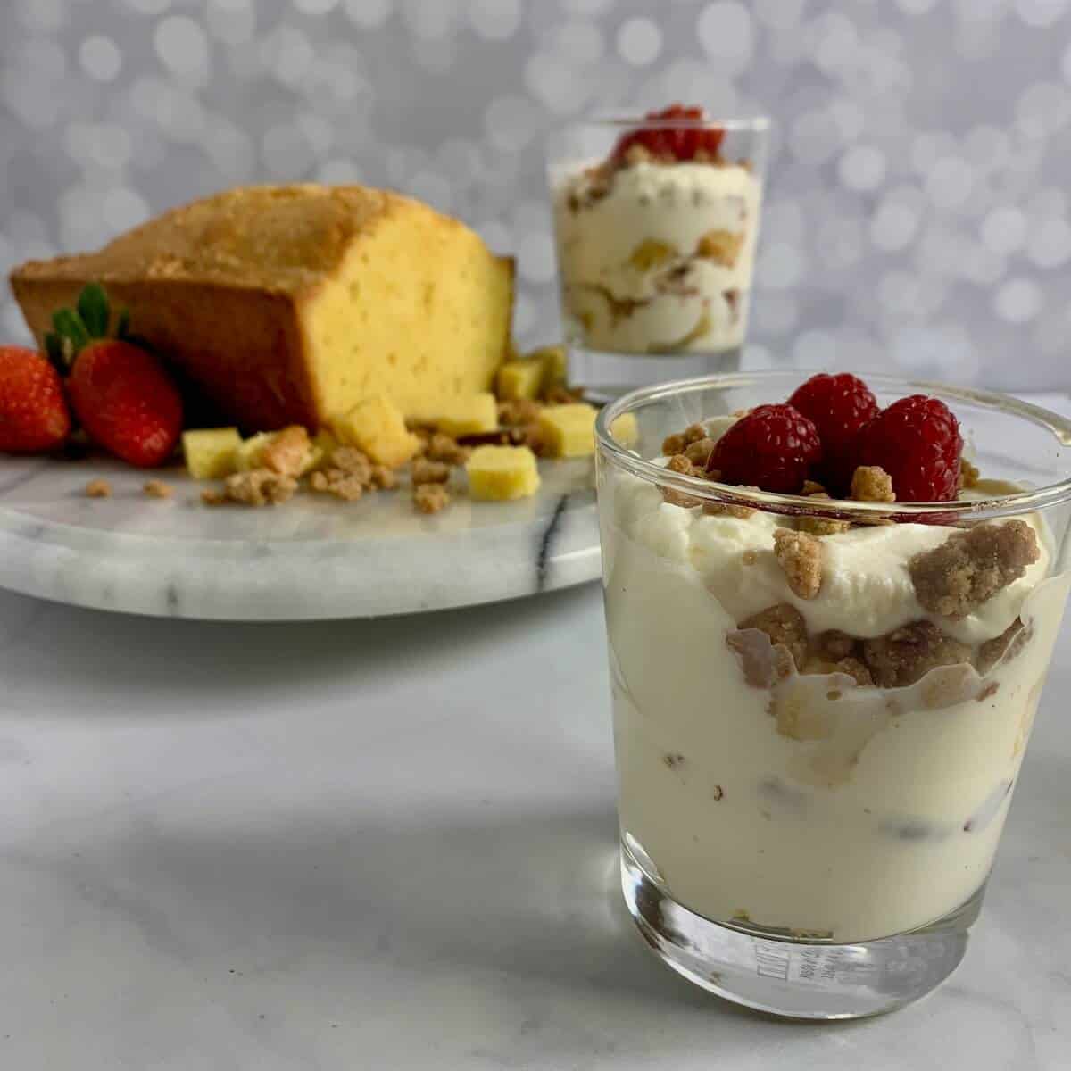 A serving of Orange Cinnamon Trifle with a pound cake and another serving in background.