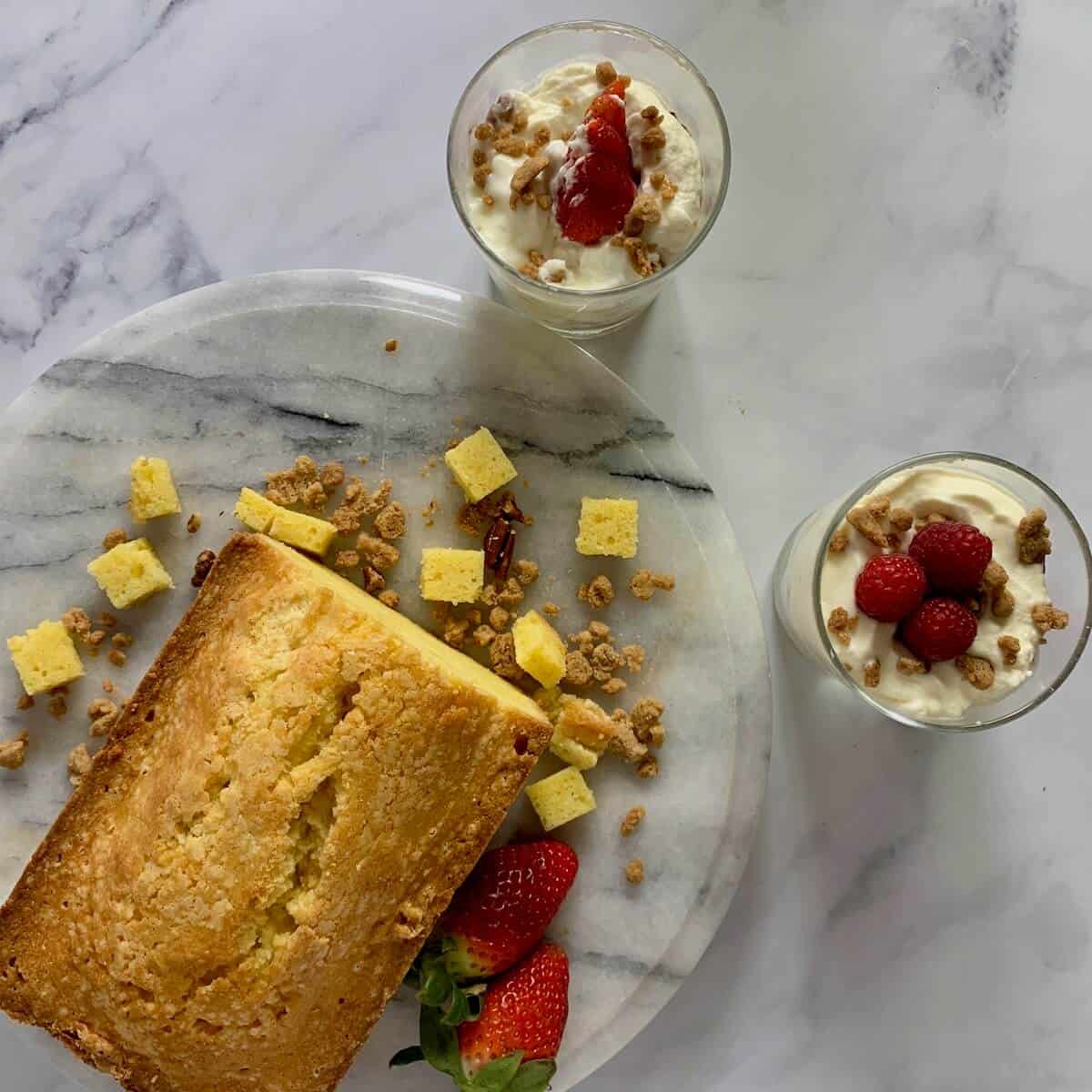 Two servings of Orange Cinnamon Trifle with a pound cake and strawberries from overhead.