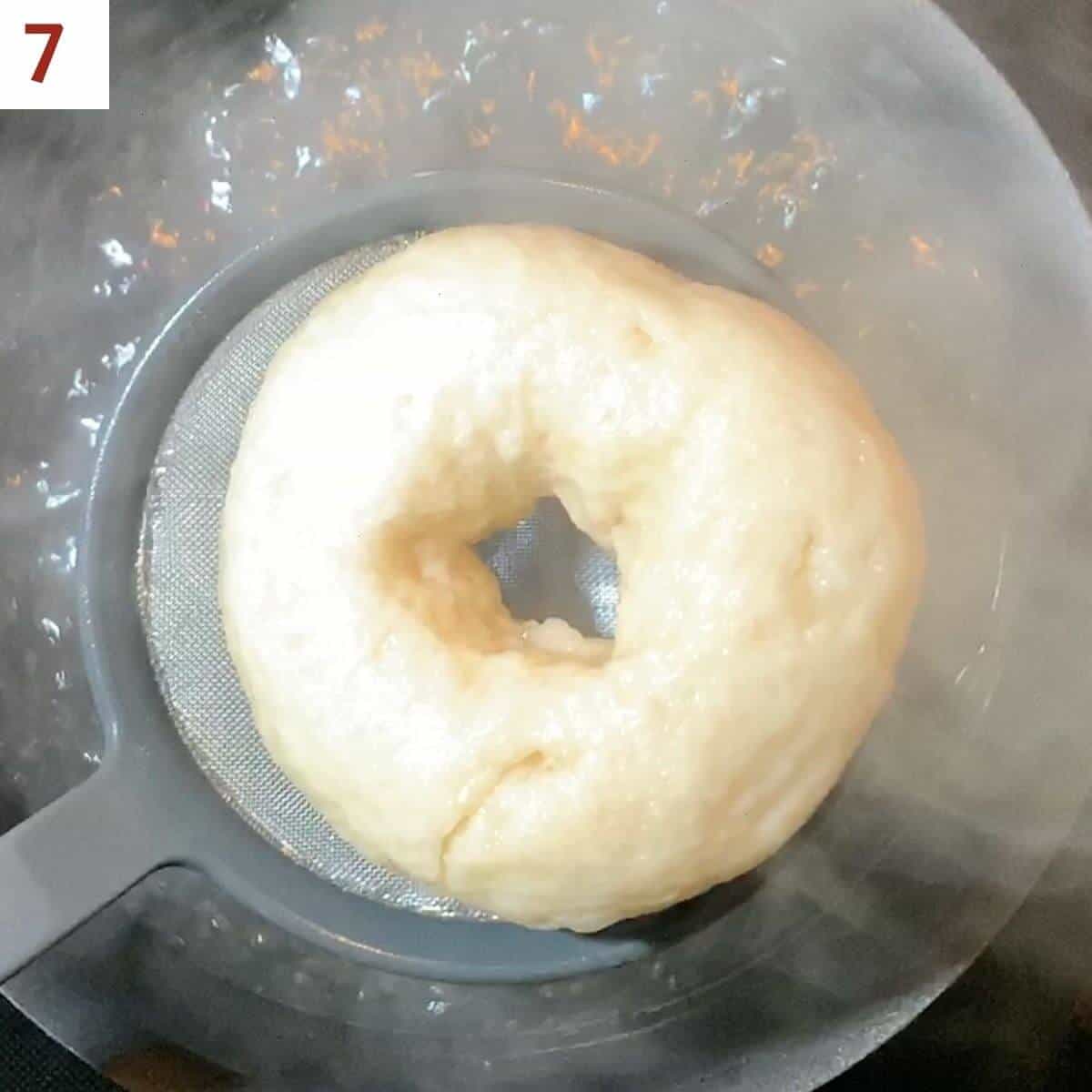 Removing bagel from the water bath.