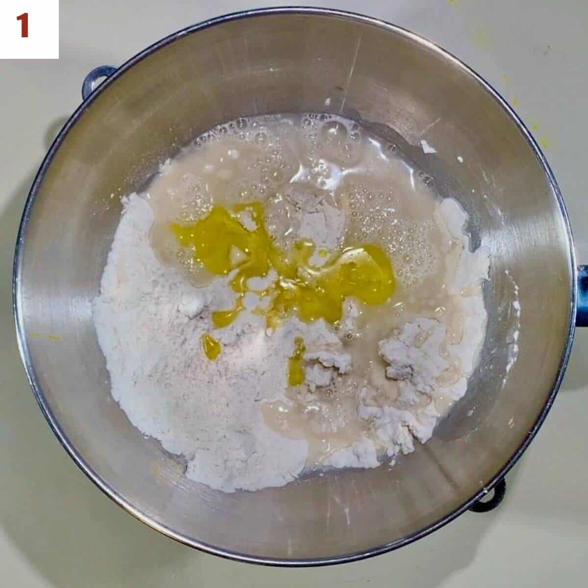 Ingredients for pizza dough in a mixing bowl.