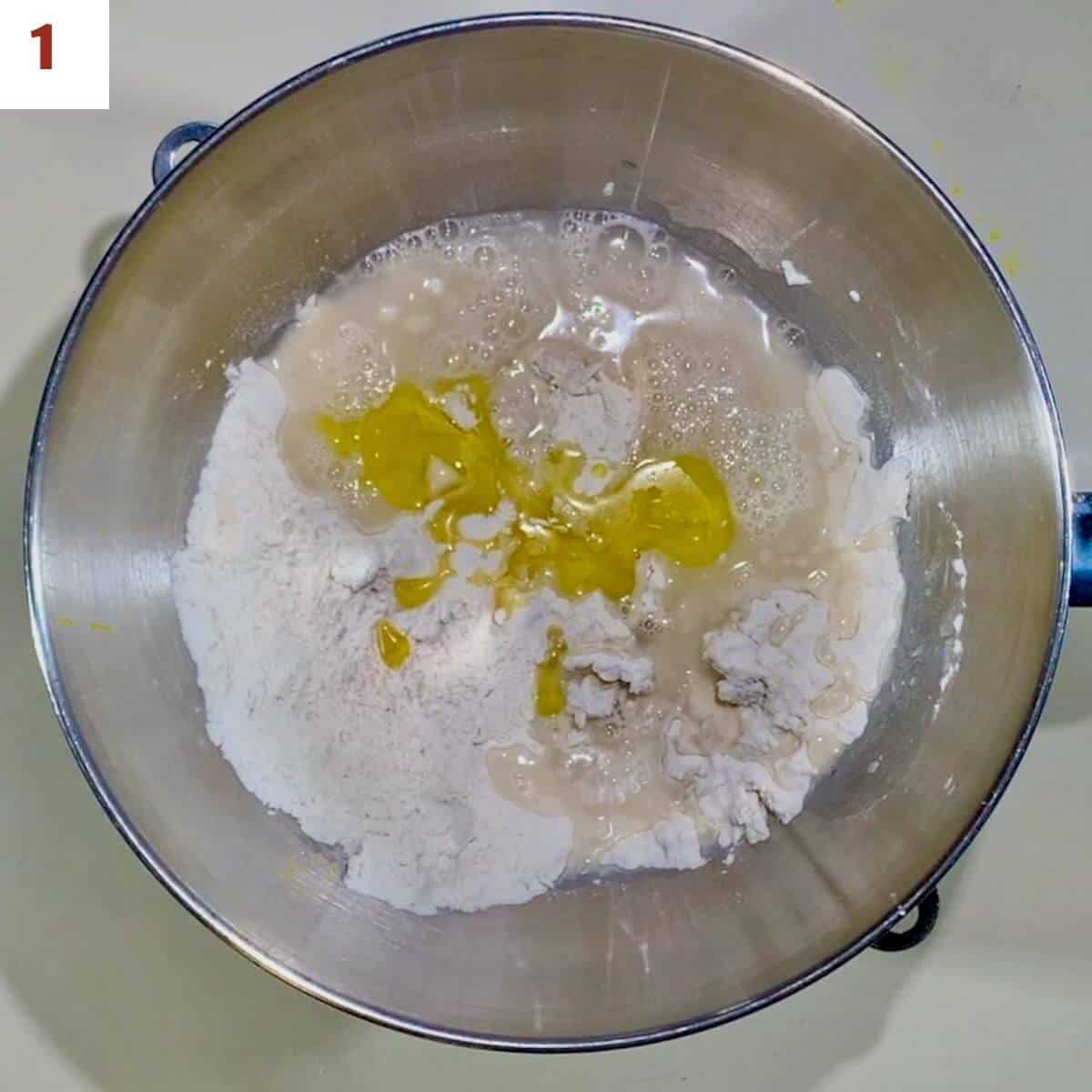 Ingredients for pizza dough in a mixing bowl.