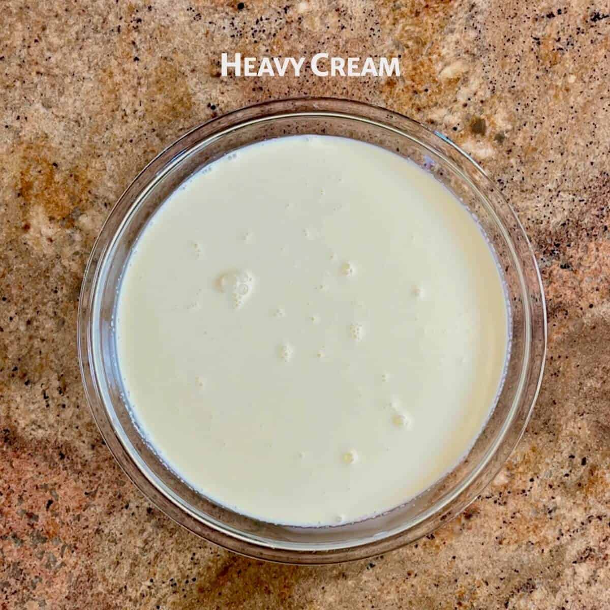 Heavy cream in a glass pie pan from overhead.