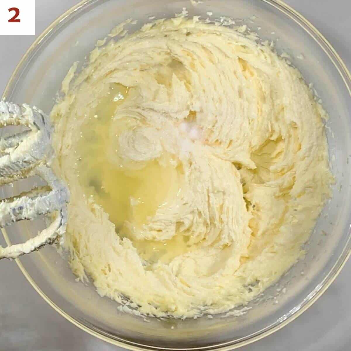 Adding lemon juice & salt to creamed butter & sugar.