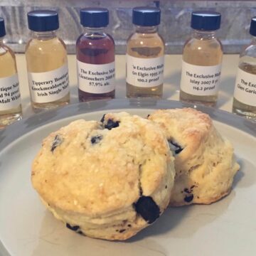 Partial lineup of Impex beverages samples in bottles with plated scones.