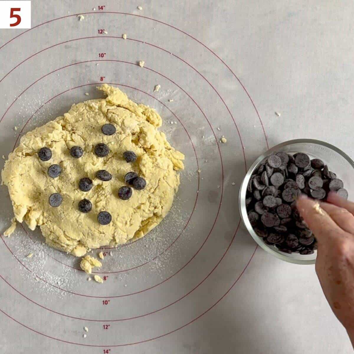 Topping scone dough with chocolate chips.