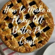 Lattice blueberry pie on a red & white striped towel next to a pie server & white plates with forks from overhead Pinterest banner.