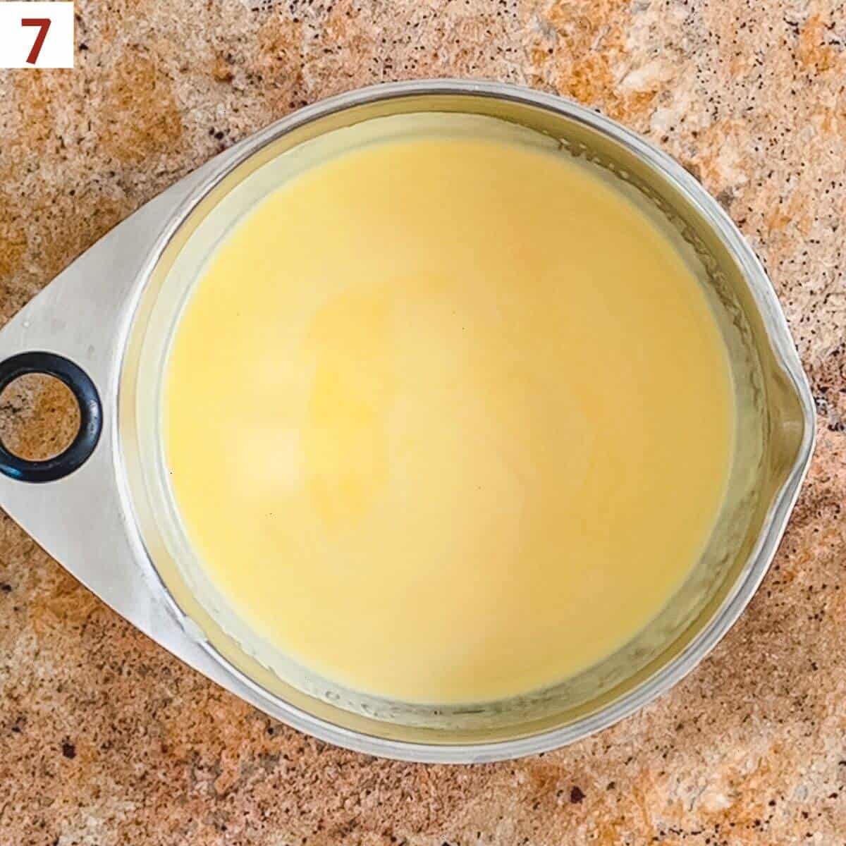 Cooled custard in a metal bowl ready to be chilled overnight.
