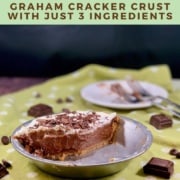 Half chocolate cream pie in the pan with 2 forks on a plate in background on a green polka dot towel Pinterest banner.