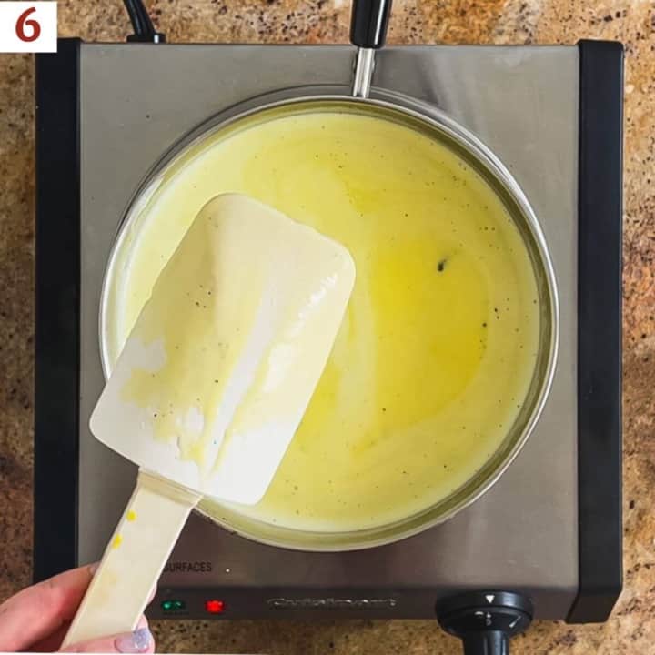 Cooked custard showing a trail on the back of a spoon.