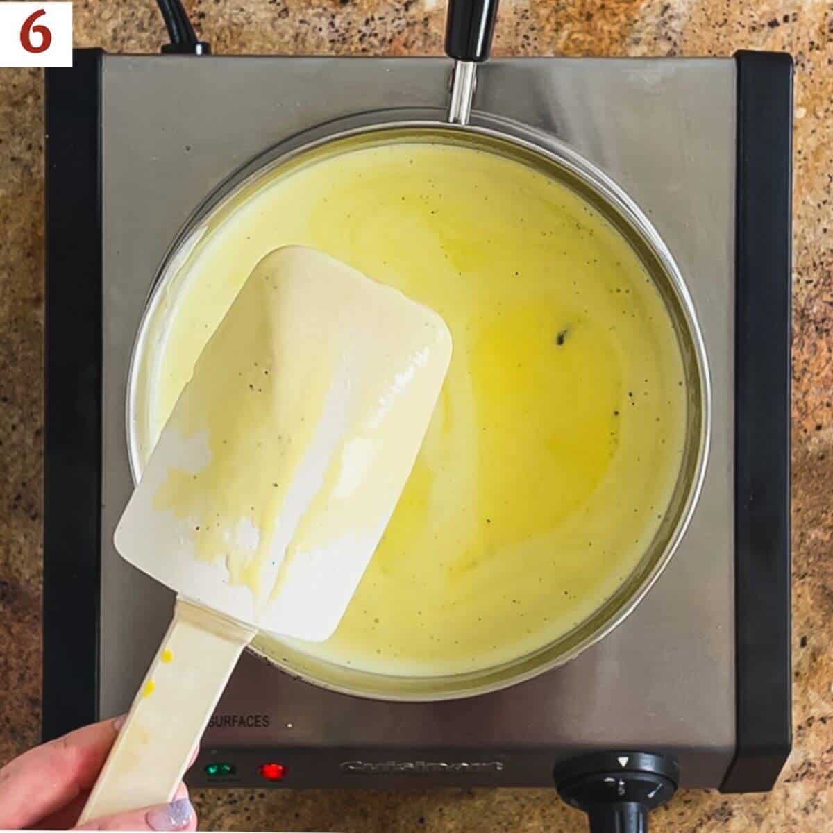 Cooked custard showing a trail on the back of a spoon.