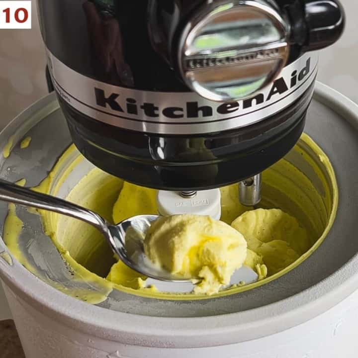 Spooning some soft ice cream from the ice cream maker to show texture.