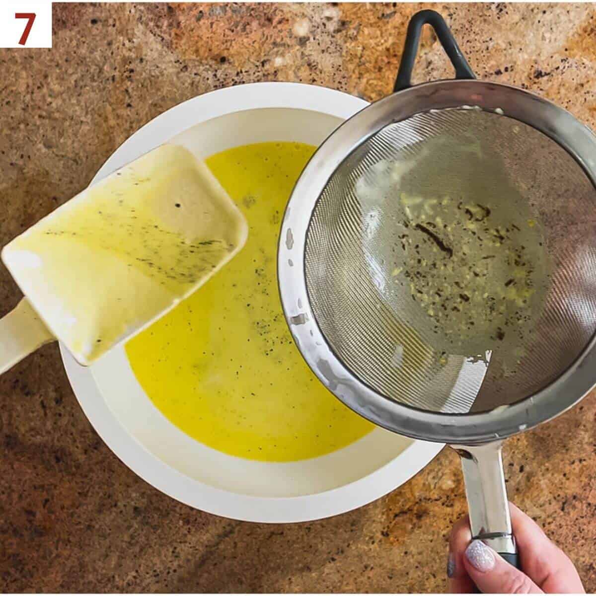 Straining out the custard base after cooking.