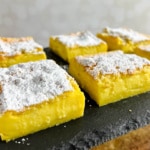Magic Custard Cake slices on a black slate platter.