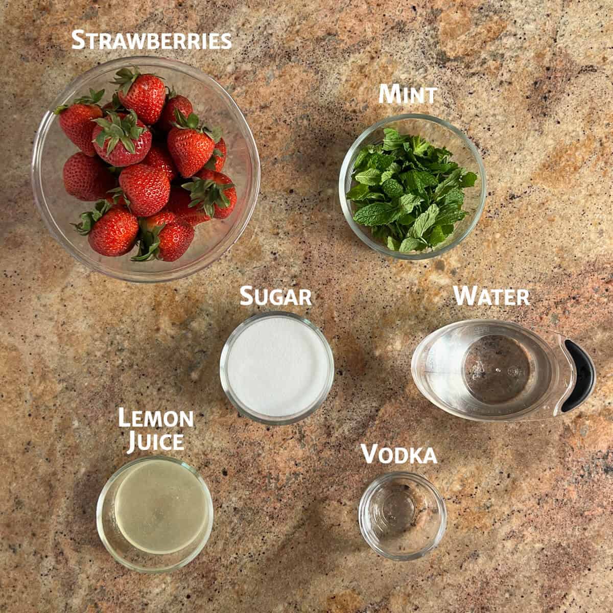 Ingredients for Strawberry Mint Sorbet portioned into glass bowls.