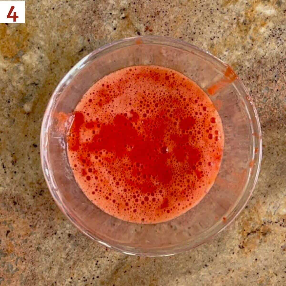 strawberry purée in a glass bowl.