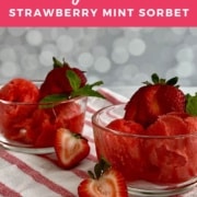 Two bowls of strawberry mint sorbet garnished with strawberries & mint on a red & white striped towel Pinterest banner.