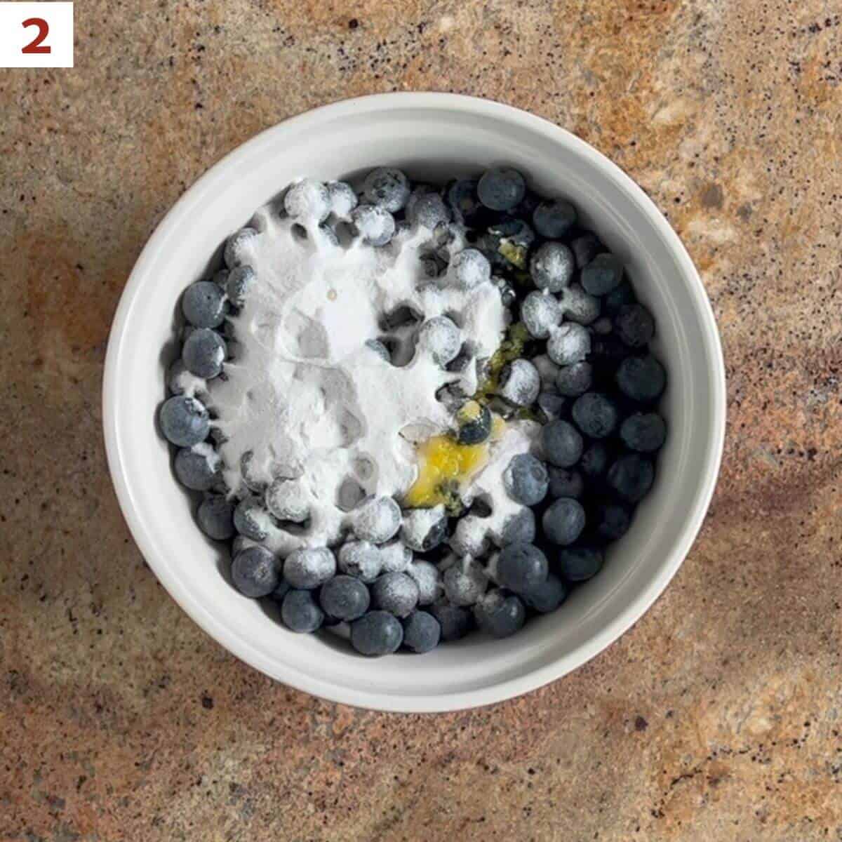 Tossing blueberries with sugar mixture and lemon juice & zest.