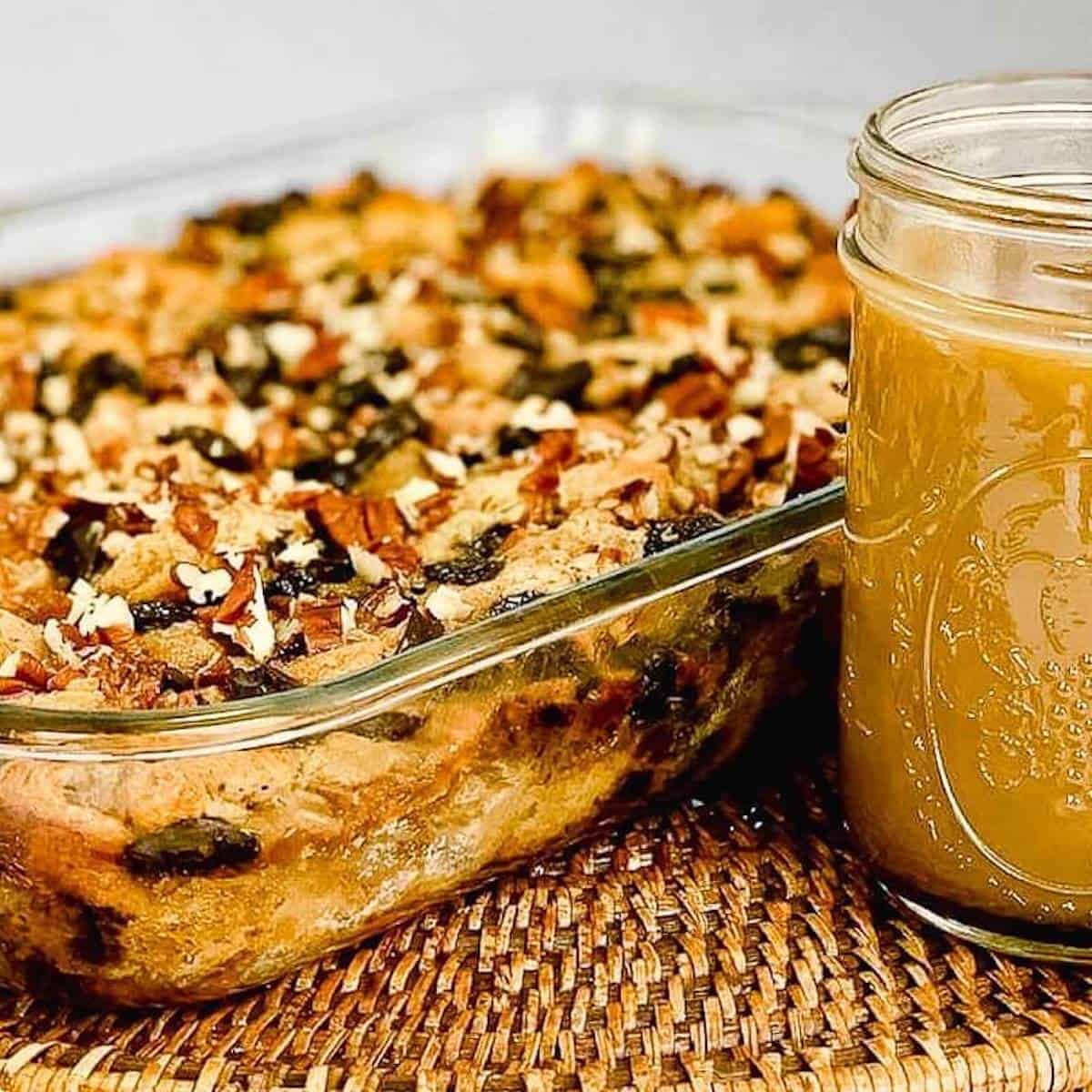 Chocolate Chip Bread Pudding with sauce on a wooden tray.