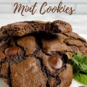 Stack of Double Chocolate Mint Cookies with the top one bitten on a white plate with mint and chocolate wafers Pinterest banner.