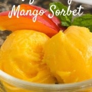 Two scoops of Mango Sorbet in a glass bowl with mango slices Pinterest banner.