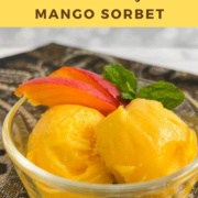 Two scoops of Mango Sorbet in a glass bowl with mango slices Pinterest banner.