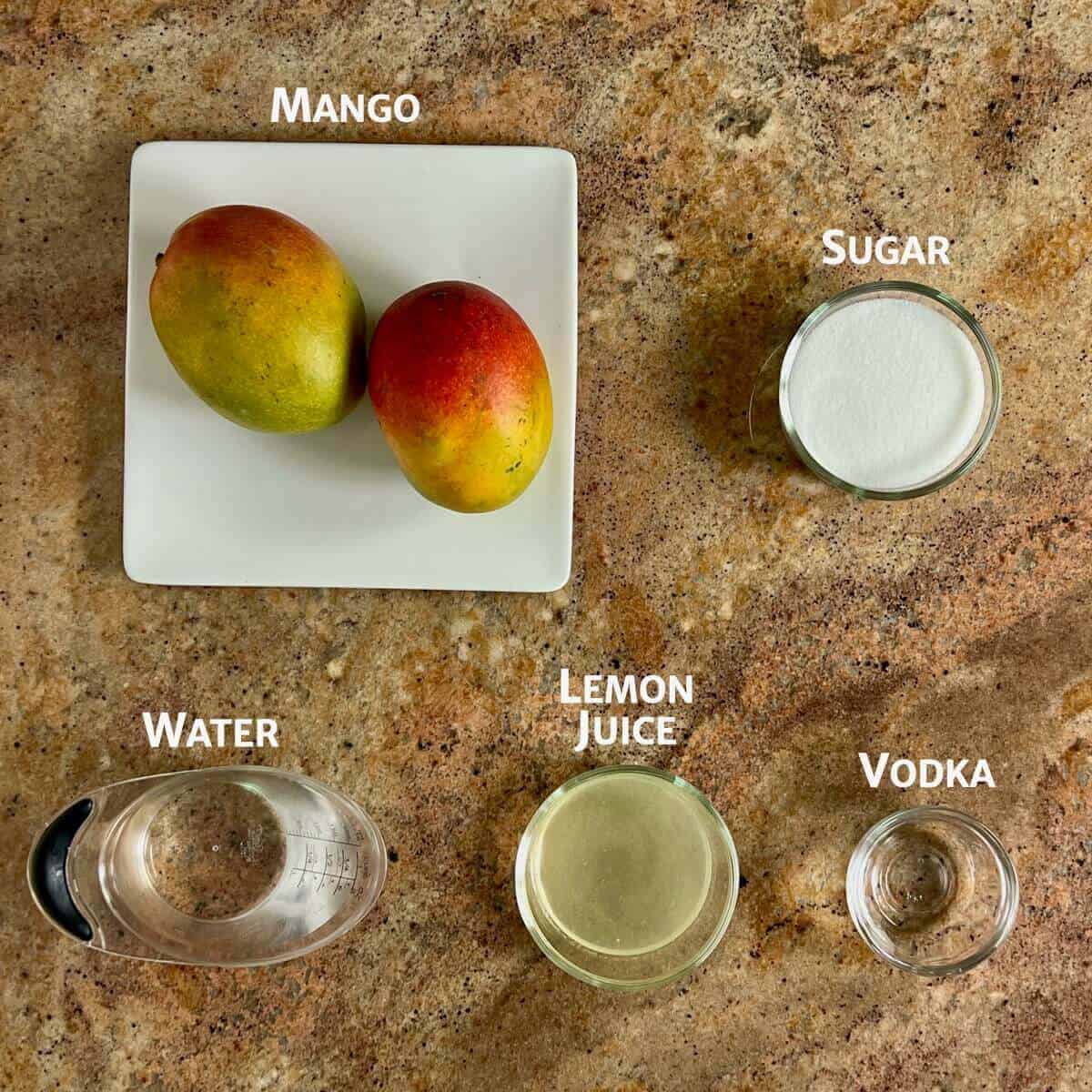 Ingredients for Mango Sorbet portioned into bowls with 2 mangos on a white square plate.