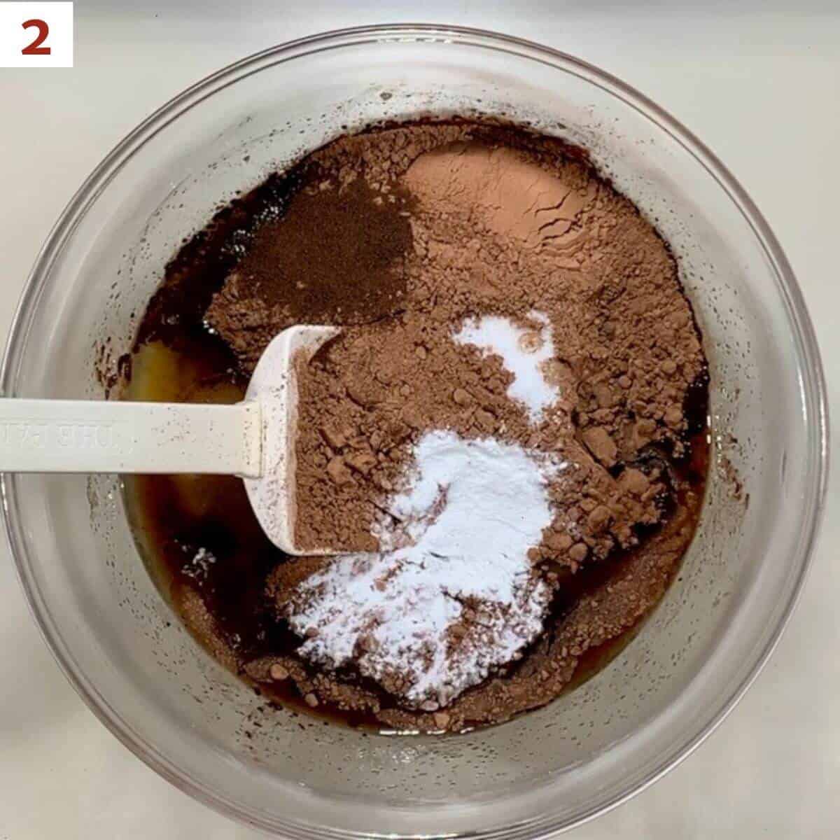 Adding Stir in the cocoa powder, vanilla, baking powder, espresso powder, and salt to the sugar mixture.