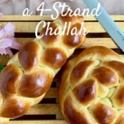 Straight challah on a cutting board with a bread knife and flowers from overhead Pinterest banner.