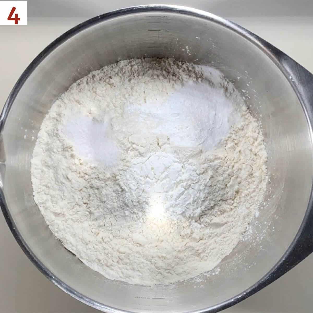 Flour, cornstarch, baking soda, and salt in a metal bowl.