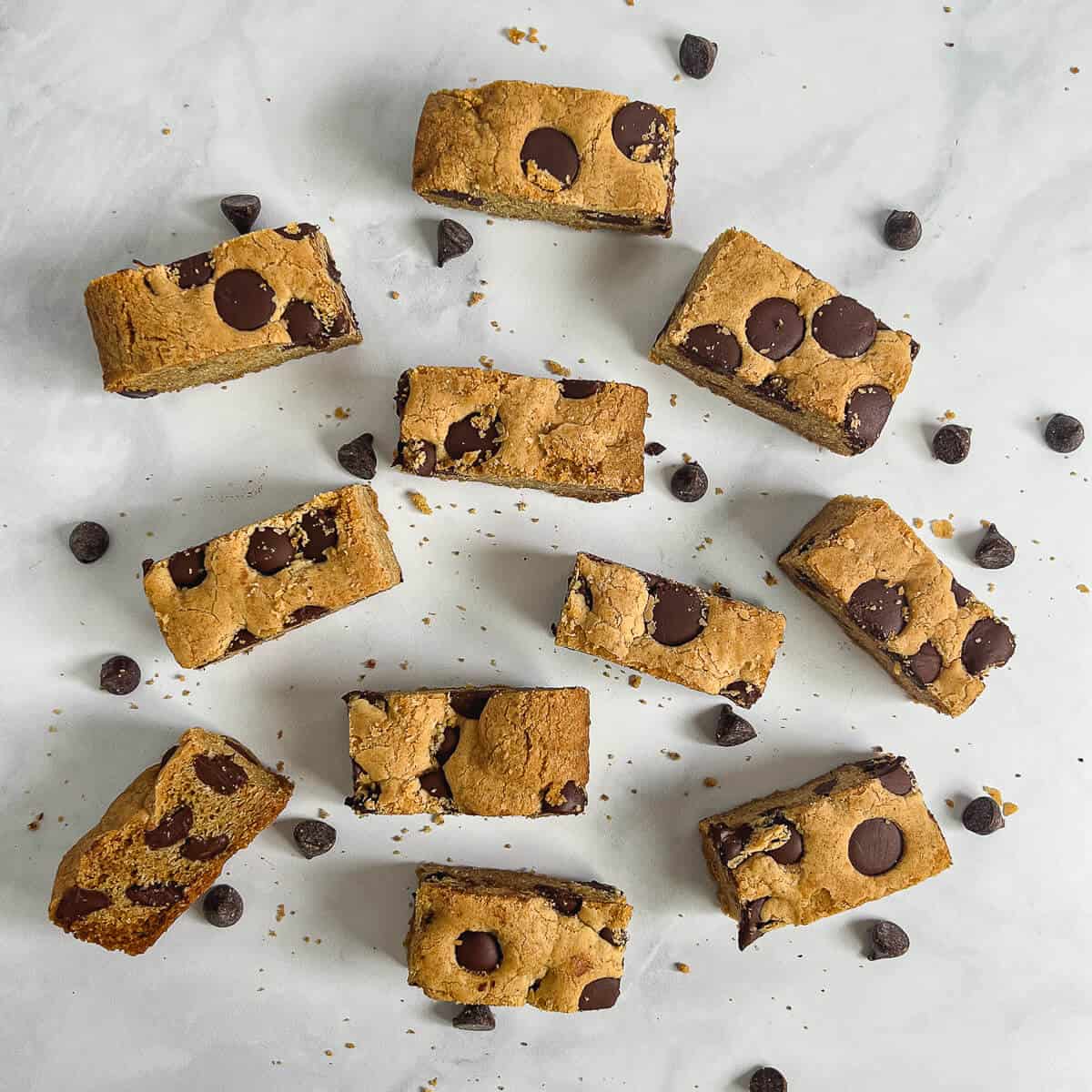 Chocolate Chip Cookie Bars scattered on a counter from overhead