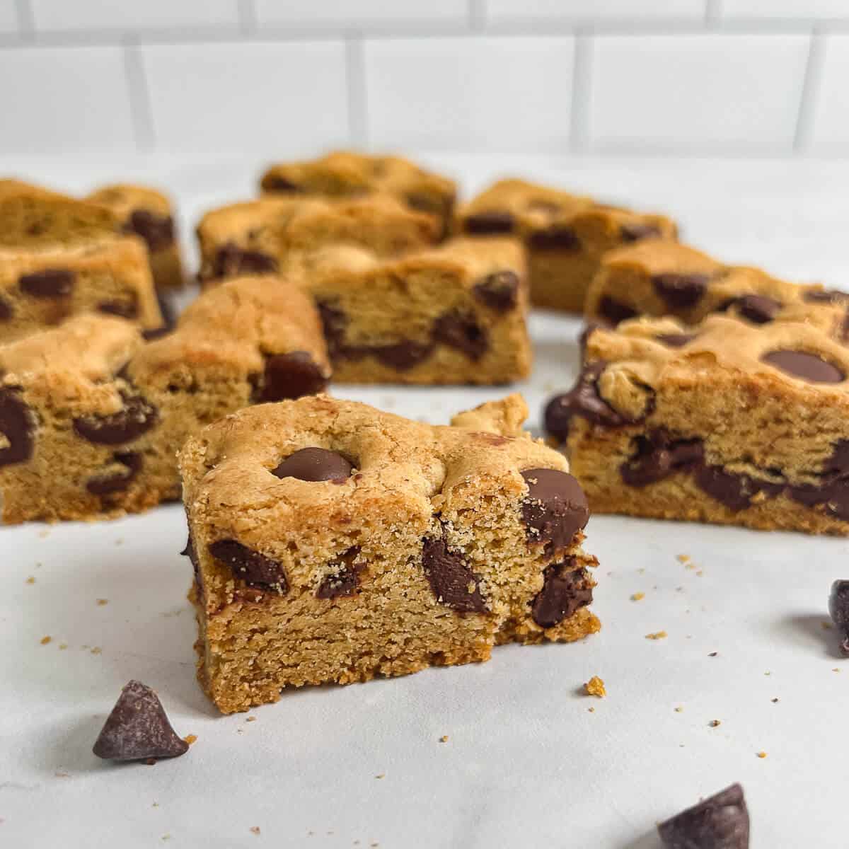 Chocolate Chip Cookie Bars scattered on a counter.