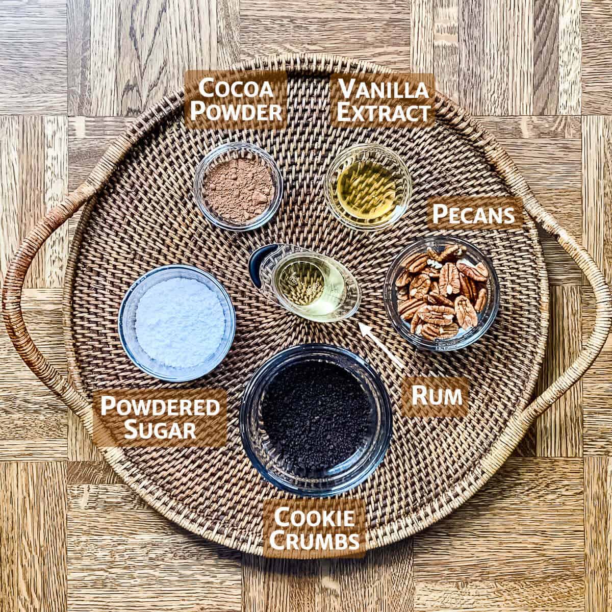 Rum Ball ingredients in bowls on a wooden tray.