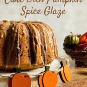 Whole sourdough pumpkin cake on a white cake stand next to a wicker cornucopia filled with gourds & small pumpkins Pinterest banner.