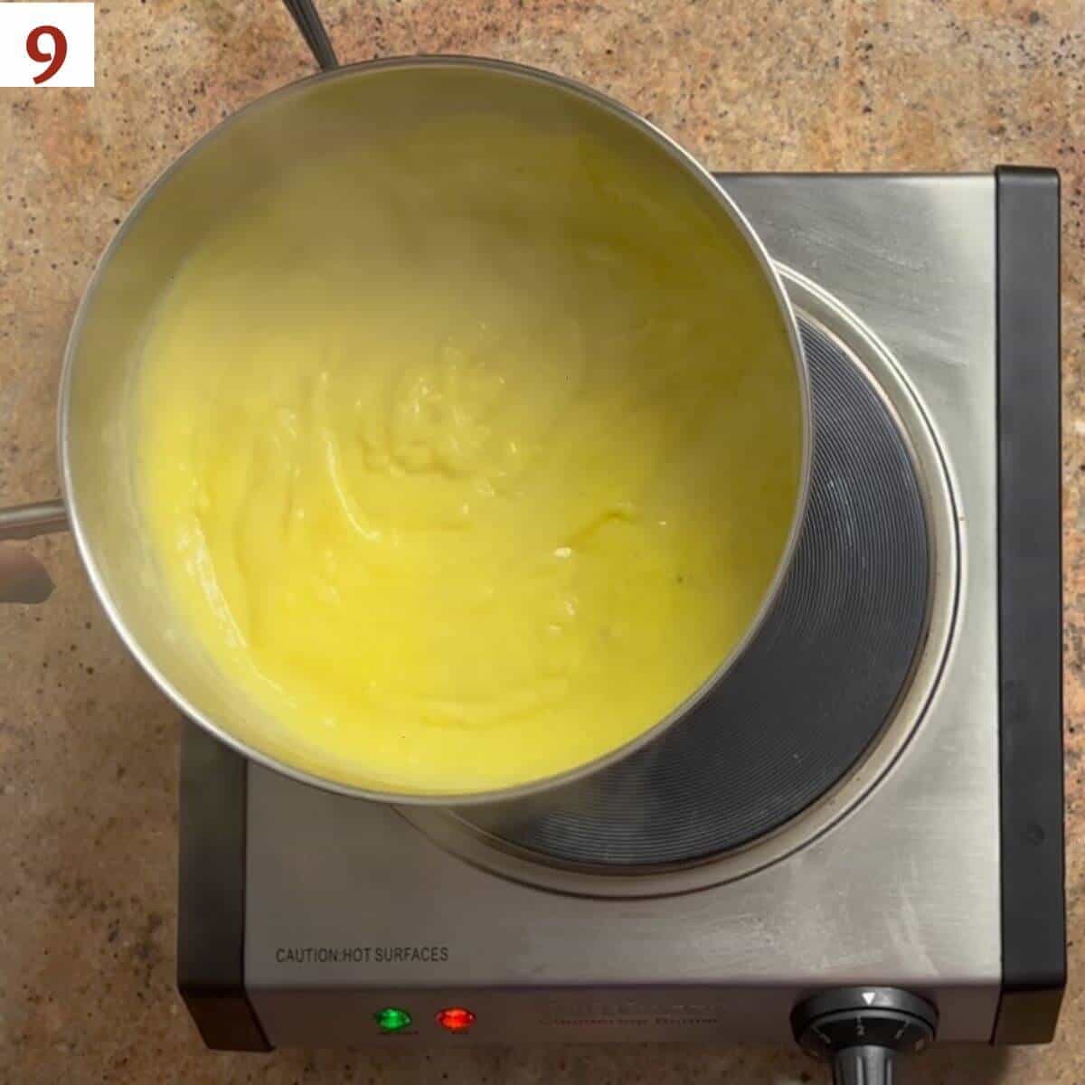 Removing cooked pastry cream from the heat.