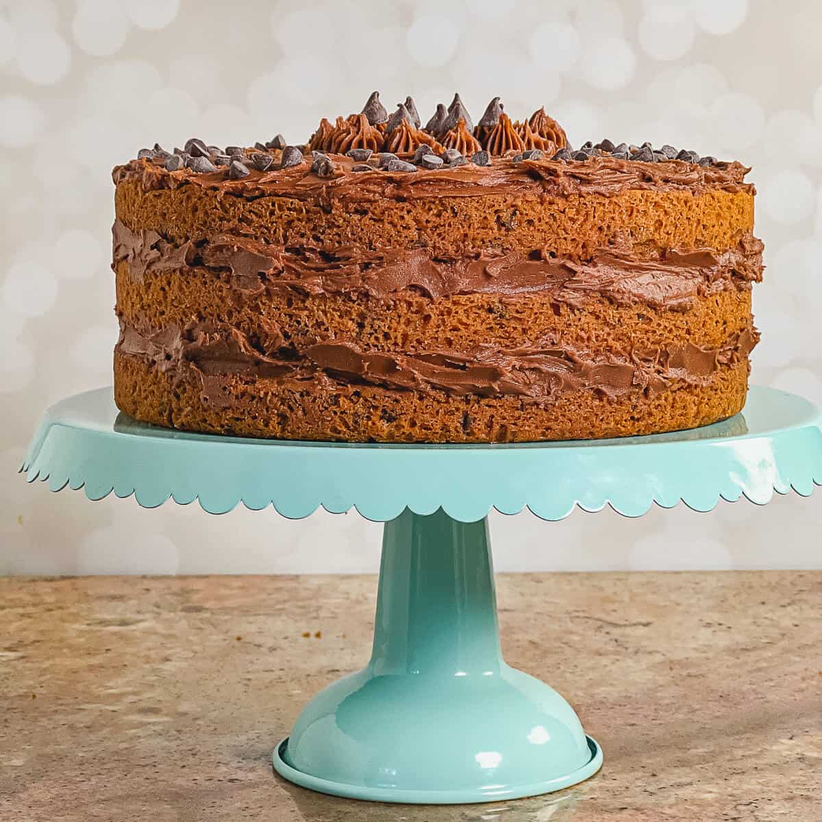 Whole Chocolate Chip Cookie Cake on a blue cake stand.