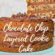 Whole Chocolate Chip Cookie Cake on a blue cake stand with a slice lifted Pinterest banner.