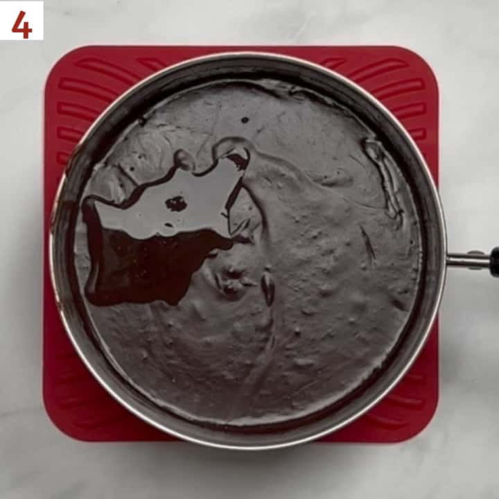 Adding vanilla extract to cooked pudding.