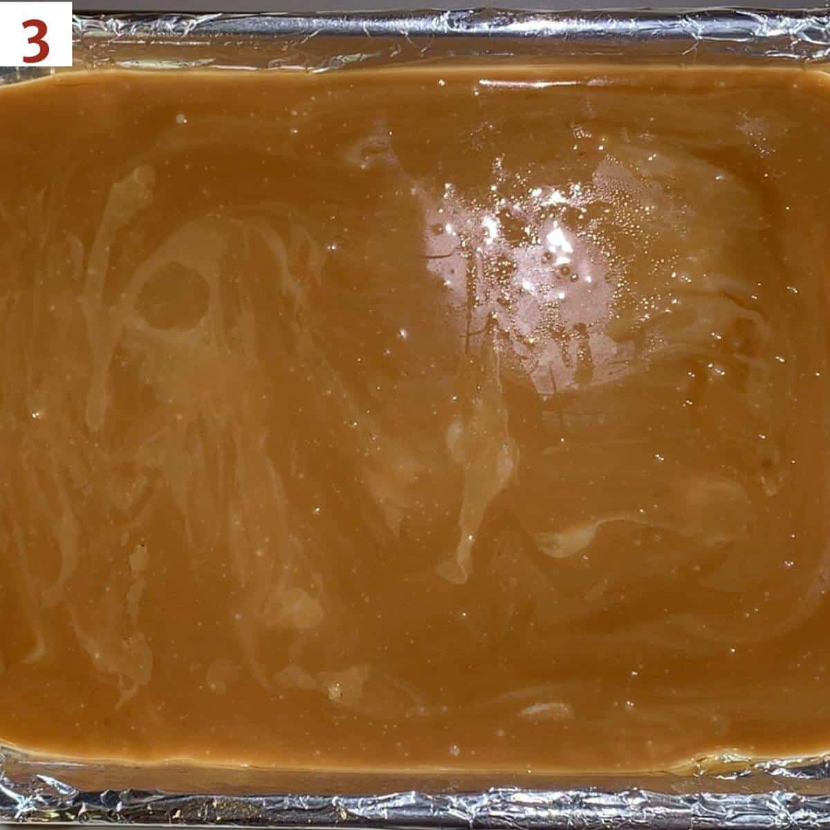 Hot toffee poured onto a greased pan.